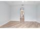 Living room with wood-look floors and archway to another room at 1341 Hayton Ave, Deland, FL 32724