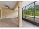 Enclosed patio featuring brick pavers, ceiling fan, and views of the landscaped yard at 1341 Hayton Ave, Deland, FL 32724