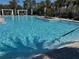 Resort-style community pool is surrounded by mature landscaping and comfortable seating at 1341 Hayton Ave, Deland, FL 32724
