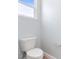 Close-up of a standard white toilet in a bathroom with wood-look flooring at 1341 Hayton Ave, Deland, FL 32724