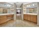 Bathroom with dual vanities, tile flooring, and a connecting hallway, exuding a clean and well-maintained atmosphere at 1491 W Silver Hammock, Deland, FL 32720