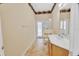 Bright bathroom featuring a shower, toilet, and vanity with a white countertop and cabinets, plus access to the outdoors at 1491 W Silver Hammock, Deland, FL 32720