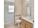 Standard bathroom features a white-tiled shower, toilet with grab bar, and vanity, ensuring a practical and accessible space at 1491 W Silver Hammock, Deland, FL 32720