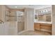 Elegant bathroom featuring a walk-in shower with glass door, tile surround, neutral wall and single vanity at 1491 W Silver Hammock, Deland, FL 32720