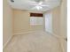 This bedroom boasts neutral walls, carpet flooring, a ceiling fan, and a closet, creating a serene and comfortable space at 1491 W Silver Hammock, Deland, FL 32720