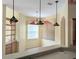 Bright breakfast nook features three pendant lights, a ceiling fan, and a large window at 1491 W Silver Hammock, Deland, FL 32720