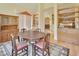 Dining room boasts a wooden table, hutch, and built-in shelves, seamlessly connects to kitchen at 1491 W Silver Hammock, Deland, FL 32720