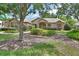 Well-maintained home with lush landscaping, a sidewalk, and stone accents on the facade at 1491 W Silver Hammock, Deland, FL 32720