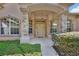 Inviting front porch with stone pillars, arched windows, and a stylish entry door at 1491 W Silver Hammock, Deland, FL 32720