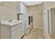 Well-equipped laundry room features a sink, storage cabinets, and modern washer and dryer units for added convenience at 1491 W Silver Hammock, Deland, FL 32720