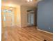 Inviting living room featuring wood floors, neutral paint, and a decorative glass front door at 1491 W Silver Hammock, Deland, FL 32720