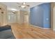 Bright living room with hardwood floors, ceiling fan and a decorative blue accent wall at 1491 W Silver Hammock, Deland, FL 32720