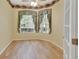 This home office boasts hardwood floors, decorative border, and paint, as well as natural light from windows with blinds at 1491 W Silver Hammock, Deland, FL 32720