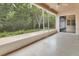Enclosed patio with screen, ceiling fan, and view of wooded area at 1491 W Silver Hammock, Deland, FL 32720