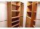 Well-organized walk-in closet with built-in shelving, drawers, and hanging rods for optimal storage solutions at 1491 W Silver Hammock, Deland, FL 32720