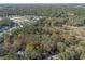 Overhead view of a property with a clearly defined boundary line, neighboring homes, and natural surroundings at 1712 Alanson Dr, Deland, FL 32724