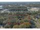 Aerial shot of a property line in red amidst a green, treed landscape, with residential areas in the distance at 1712 Alanson Dr, Deland, FL 32724