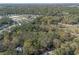An aerial view showing the mature trees and wooded lot with the convenience of a nearby community of homesites at 1712 Alanson Dr, Deland, FL 32724