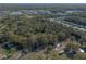 An aerial view showing this private wooded homesite surrounded by nature and nearby community of homesites at 1712 Alanson Dr, Deland, FL 32724