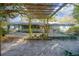 Charming backyard with a pergola, gazebo, wooden deck, and fish pond with surrounding tropical landscaping at 1712 Alanson Dr, Deland, FL 32724