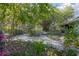 Secluded backyard with a pergola, gazebo, wooden deck, fish pond, and surrounded by mature trees at 1712 Alanson Dr, Deland, FL 32724