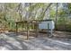 Large backyard with a chicken coop, ample space, and surrounded by mature trees at 1712 Alanson Dr, Deland, FL 32724