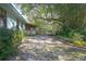 Screened porch overlooks lush backyard with wooden deck, a gazebo, and mature trees offering shade and privacy at 1712 Alanson Dr, Deland, FL 32724