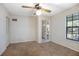 Neutral bedroom with wall paneling, ceiling fan, and natural light at 1712 Alanson Dr, Deland, FL 32724