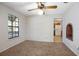 Neutral bedroom with paneling, ceiling fan, natural light, and brick detail at 1712 Alanson Dr, Deland, FL 32724