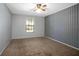 Simple bedroom with painted walls, carpet floor, ceiling fan and double hung window at 1712 Alanson Dr, Deland, FL 32724