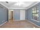 Carpeted bedroom boasts wallpaper, ceiling fan, double hung windows and closet at 1712 Alanson Dr, Deland, FL 32724
