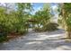 Long driveway leading to a house surrounded by mature trees and lush greenery at 1712 Alanson Dr, Deland, FL 32724