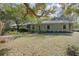 Charming single-story home with a covered porch surrounded by mature trees at 1712 Alanson Dr, Deland, FL 32724