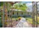 Charming home with covered porch framed by a decorative archway and lush greenery at 1712 Alanson Dr, Deland, FL 32724