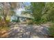 Charming home exterior surrounded by lush landscaping, mature trees, and blooming azaleas for added curb appeal at 1712 Alanson Dr, Deland, FL 32724