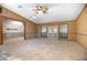 Bright living room boasts wood paneling, skylight, carpet flooring and access to an outdoor patio at 1712 Alanson Dr, Deland, FL 32724