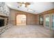 Bright living room boasts wood paneling, skylight, carpet flooring and stone fireplace at 1712 Alanson Dr, Deland, FL 32724