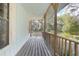 Spacious covered porch with wood railings, offering serene outdoor living at 1712 Alanson Dr, Deland, FL 32724