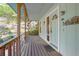 Cozy covered porch with wood railings and light blue door, inviting entry at 1712 Alanson Dr, Deland, FL 32724