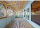 Screened porch with wood floors and ceiling offers backyard views at 1712 Alanson Dr, Deland, FL 32724
