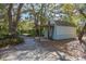 Detached shed in the backyard offers extra storage with a quaint covered porch, and a brick paver pathway at 1712 Alanson Dr, Deland, FL 32724
