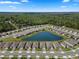 Aerial view of a lakefront community featuring homes situated around a beautiful, serene lake at 1716 Red Rock Rd, New Smyrna Beach, FL 32168
