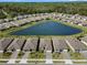 Aerial view of a community showcasing homes around a tranquil lake at 1716 Red Rock Rd, New Smyrna Beach, FL 32168