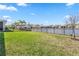 Beautiful backyard with a lake view and a black metal fence at 1716 Red Rock Rd, New Smyrna Beach, FL 32168