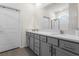 Bathroom featuring a double vanity with quartz countertop and gray cabinets at 1716 Red Rock Rd, New Smyrna Beach, FL 32168
