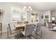 Bright dining area features a table for six with natural light and access to the patio and backyard at 1716 Red Rock Rd, New Smyrna Beach, FL 32168