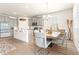 Bright dining area with modern chandelier, table for six, and natural light streaming through the shuttered windows at 1716 Red Rock Rd, New Smyrna Beach, FL 32168