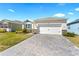Wide driveway with stone pavers leading up to the home's attached garage, flanked by well-maintained lawns at 1716 Red Rock Rd, New Smyrna Beach, FL 32168