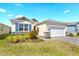 Charming single Gathering home featuring a well maintained lawn, an attached garage, and stone veneer accents at 1716 Red Rock Rd, New Smyrna Beach, FL 32168