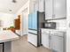 The kitchen features stainless steel appliances, gray cabinets, white quartz countertops, and wood-look tile floors at 1716 Red Rock Rd, New Smyrna Beach, FL 32168